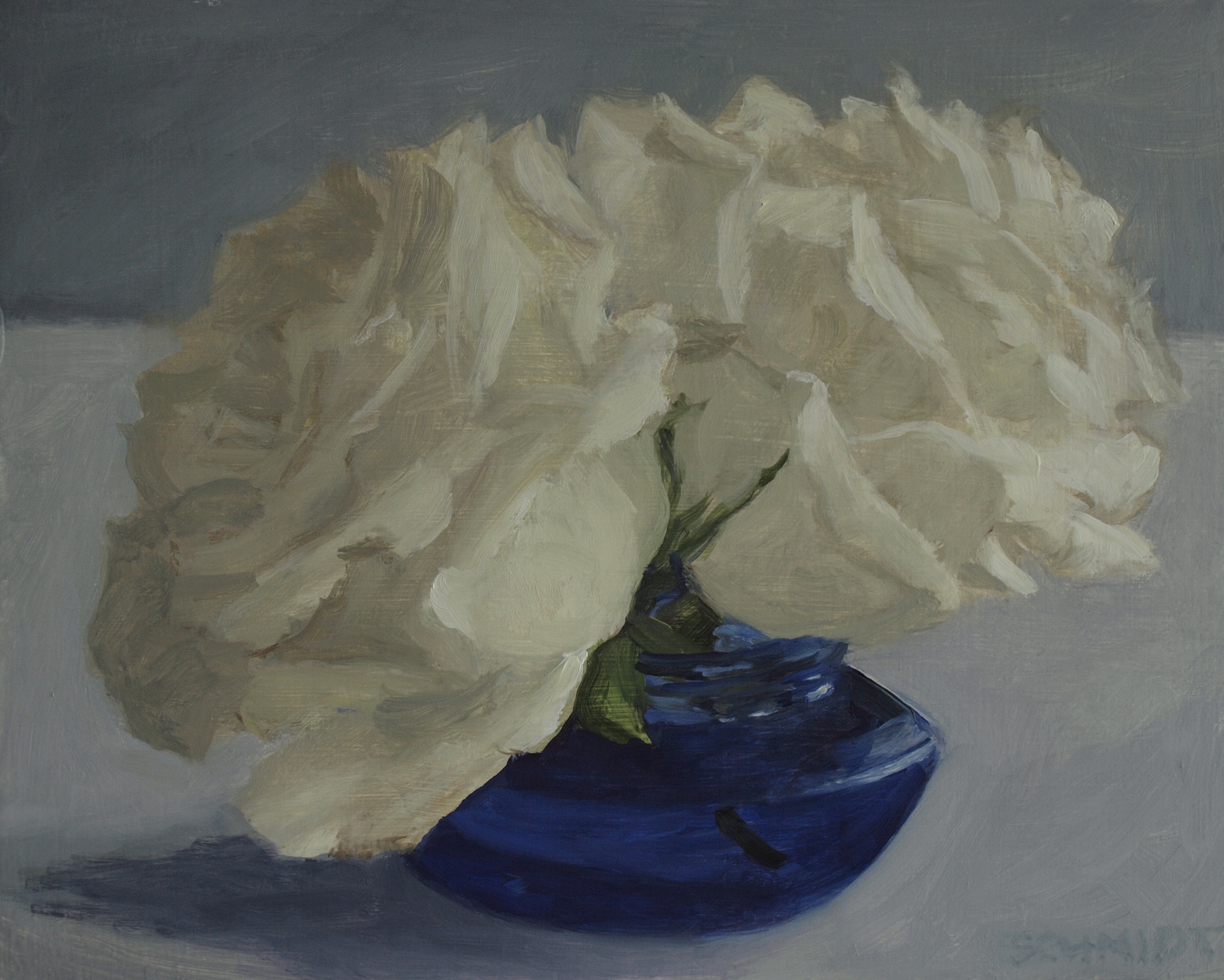 two white roses in blue glass jar