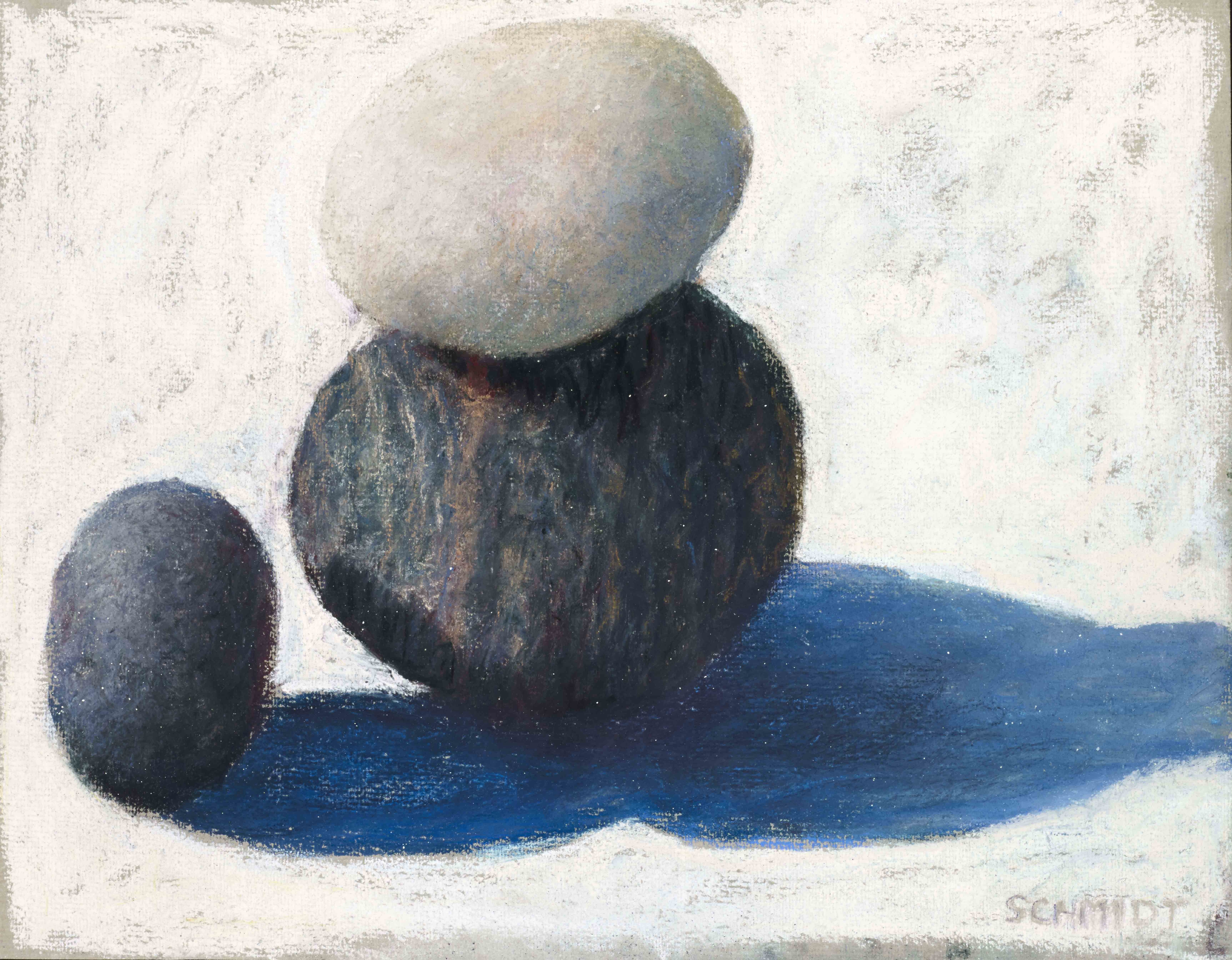 3 rocks, one looks like and black egg